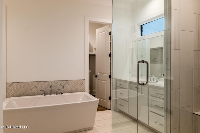 bathroom with vanity, tile walls, and separate shower and tub