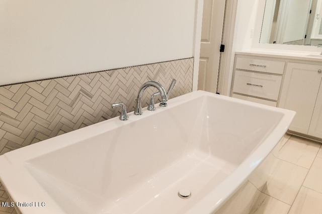 bathroom with vanity, tile walls, a tub to relax in, and tile patterned flooring