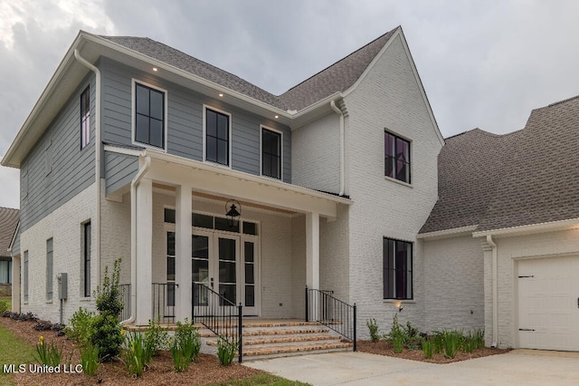 view of front of home with a porch and a garage