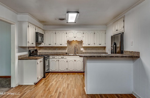 204 Turtle Creek Dr, Brandon, MS 39047 - kitchen with black appliances, dark countertops, a sink, and crown molding