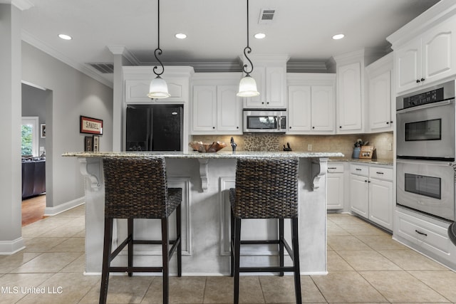 kitchen with white cabinetry, appliances with stainless steel finishes, and a kitchen island