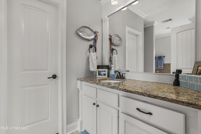 bathroom featuring vanity and ornamental molding