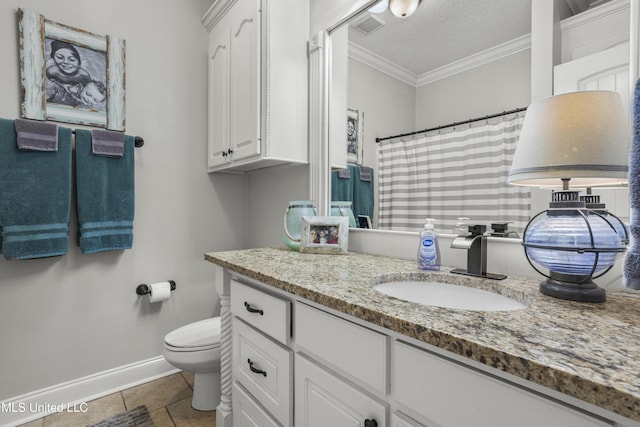 bathroom with vanity, toilet, crown molding, tile patterned floors, and a textured ceiling