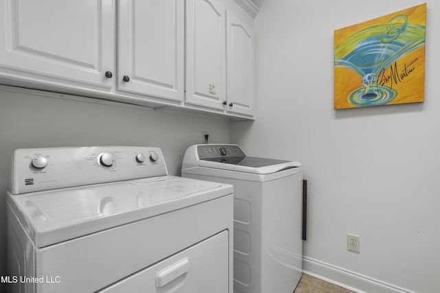 clothes washing area with cabinets and separate washer and dryer