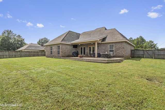 back of property featuring a yard