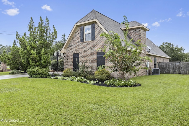 view of property exterior featuring a yard and central AC