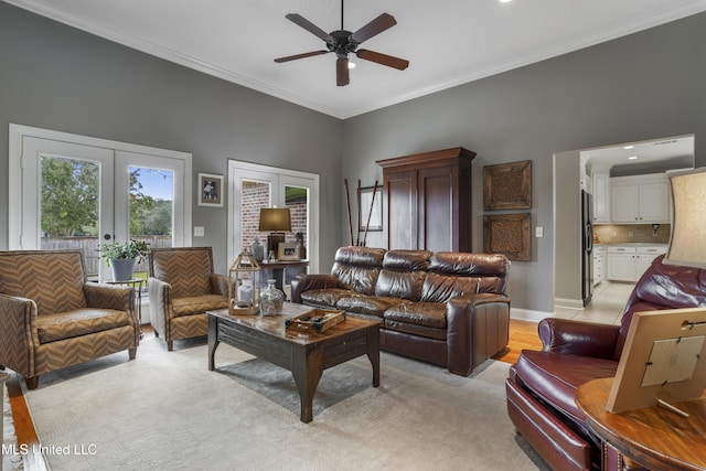 living room featuring crown molding, french doors, and ceiling fan