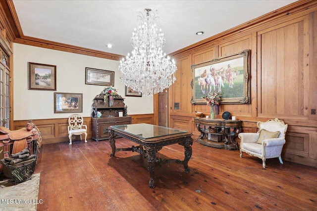 living area featuring crown molding, dark hardwood / wood-style floors, and a notable chandelier