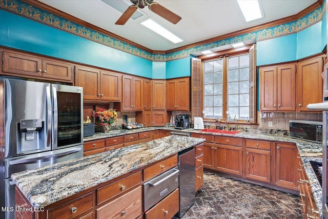 kitchen featuring stainless steel fridge, light stone countertops, sink, and ornamental molding