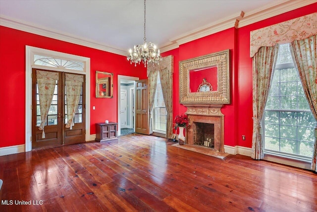 interior space with a premium fireplace, hardwood / wood-style floors, and crown molding