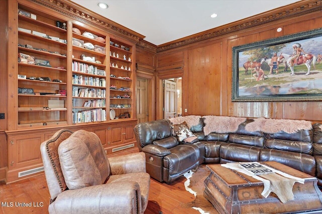 living room featuring light hardwood / wood-style floors and wooden walls