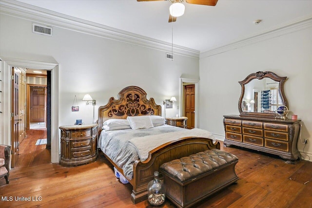 bedroom featuring hardwood / wood-style flooring, ceiling fan, and ornamental molding