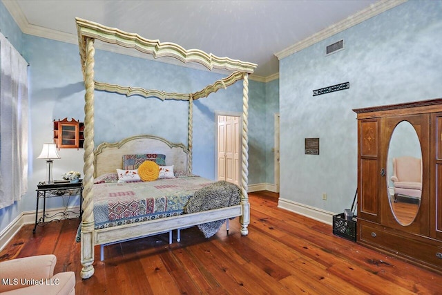 bedroom with dark hardwood / wood-style flooring and crown molding