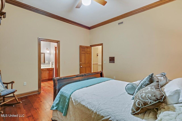 bedroom featuring hardwood / wood-style flooring, ceiling fan, ornamental molding, and connected bathroom