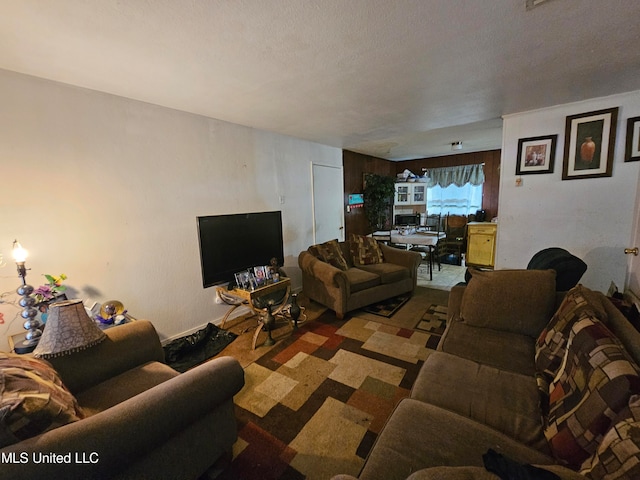 living room with a textured ceiling and carpet