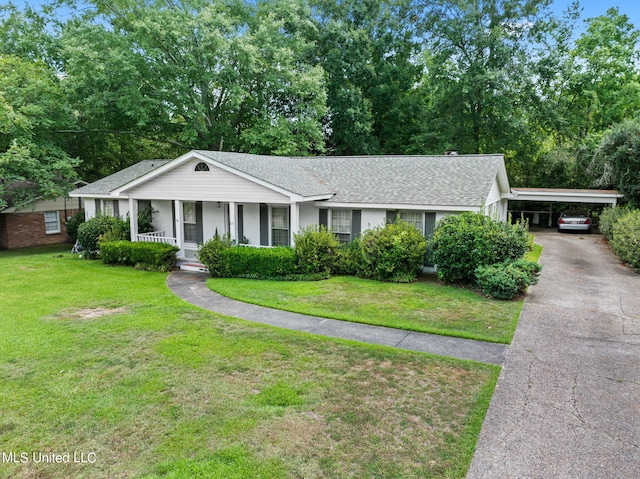 ranch-style home with a carport, covered porch, and a front lawn