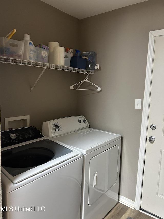15501 Quail Creek Cv, Diberville, MS 39540 - laundry area with independent washer and dryer, wood finished floors, and baseboards