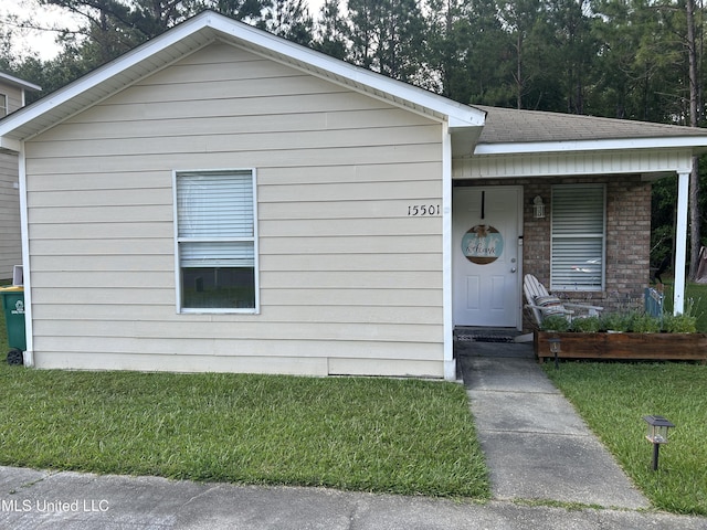 15501 Quail Creek Cv, Diberville, MS 39540 - view of front of house featuring a front yard, covered porch, and brick siding