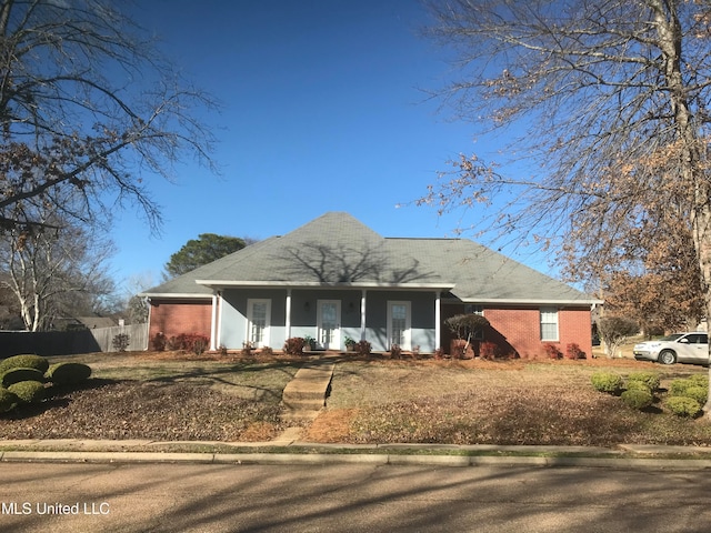 view of front of property featuring a porch and a garage