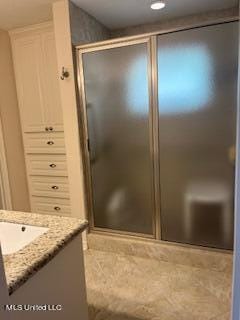 bathroom featuring vanity, tile patterned floors, and an enclosed shower