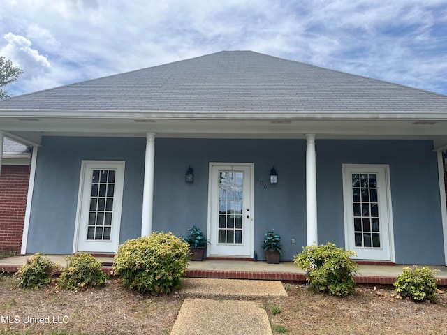 view of exterior entry with a porch