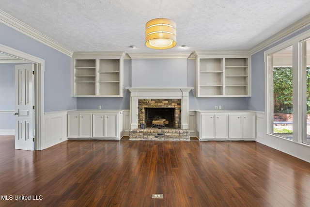 1034 Northpointe Dr, Jackson, MS 39211 - unfurnished living room featuring dark wood finished floors, a textured ceiling, wainscoting, a brick fireplace, and crown molding