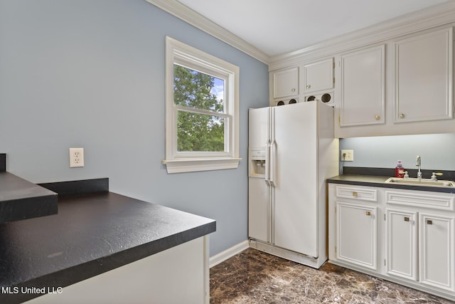 1034 Northpointe Dr, Jackson, MS 39211 - kitchen featuring white fridge with ice dispenser, a sink, dark countertops, white cabinets, and crown molding