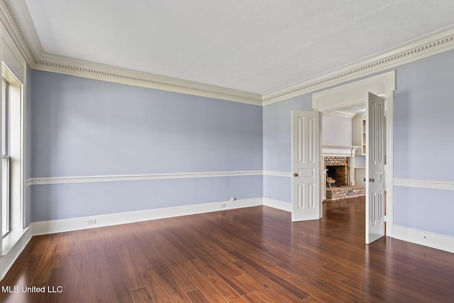 1034 Northpointe Dr, Jackson, MS 39211 - empty room featuring crown molding, baseboards, wood finished floors, and a brick fireplace