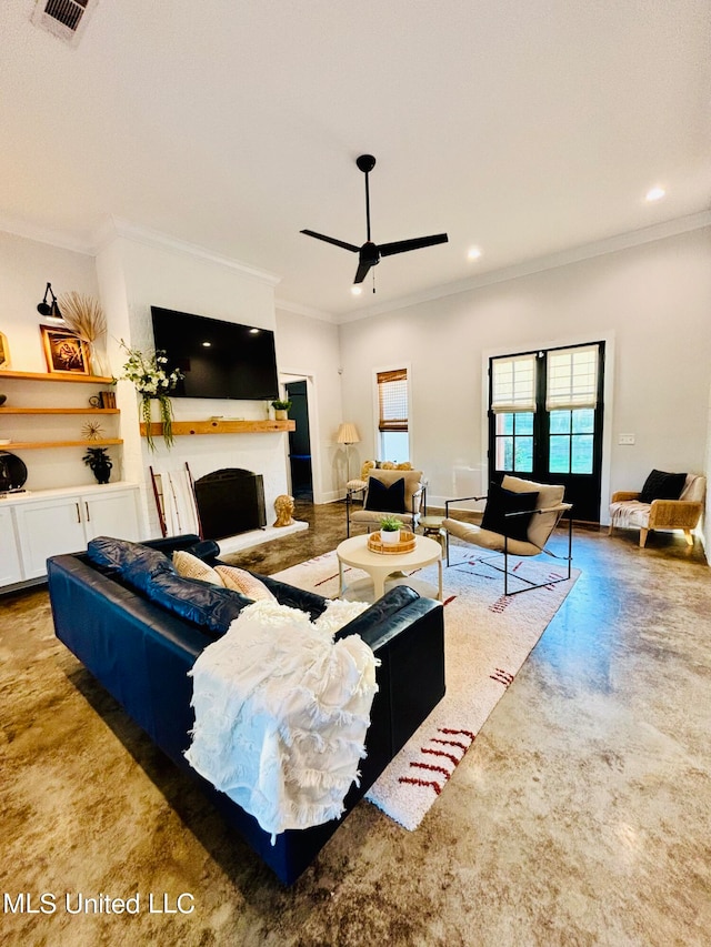 living room with ornamental molding and ceiling fan