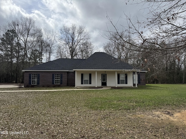 ranch-style house with a porch and a front lawn