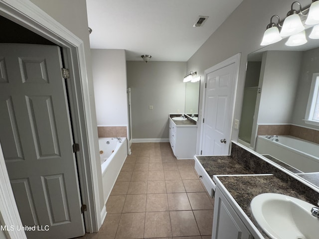 bathroom featuring vanity, tile patterned floors, a tub, and a chandelier