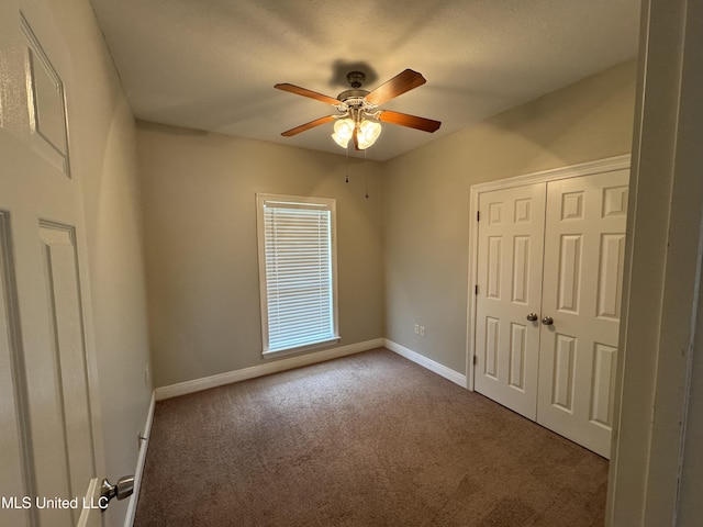 spare room featuring carpet floors and ceiling fan