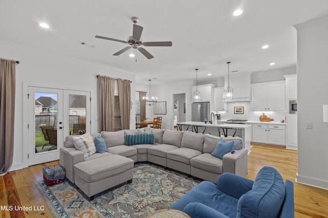970 Glenwild Cir, Canton, MS 39046 - living area with recessed lighting, light wood finished floors, ceiling fan, ornamental molding, and a chandelier