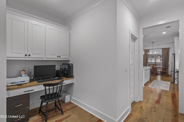 970 Glenwild Cir, Canton, MS 39046 - office with built in desk, ornamental molding, light wood-type flooring, a chandelier, and baseboards