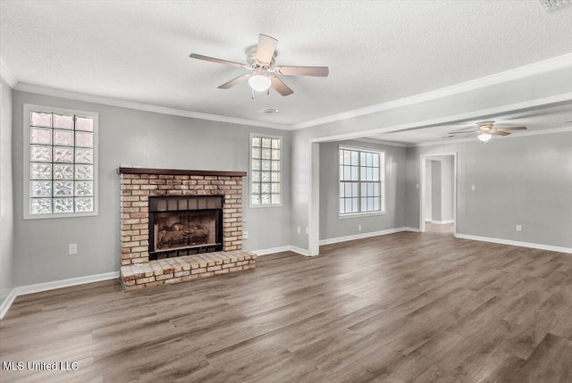 unfurnished living room featuring ornamental molding, hardwood / wood-style floors, and a textured ceiling