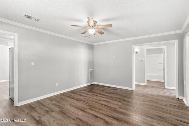 empty room with crown molding, a textured ceiling, dark hardwood / wood-style floors, and ceiling fan