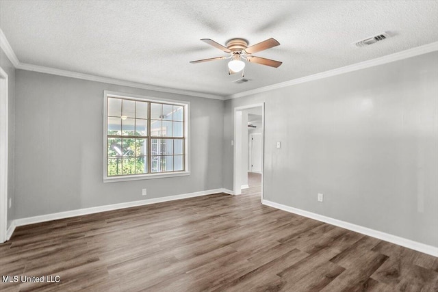 unfurnished room with dark hardwood / wood-style flooring, ornamental molding, and a textured ceiling