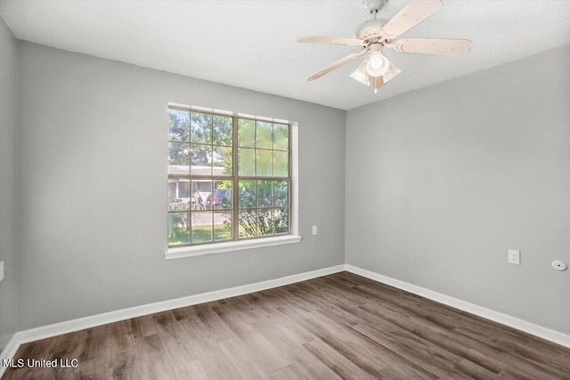 unfurnished room with hardwood / wood-style floors and ceiling fan