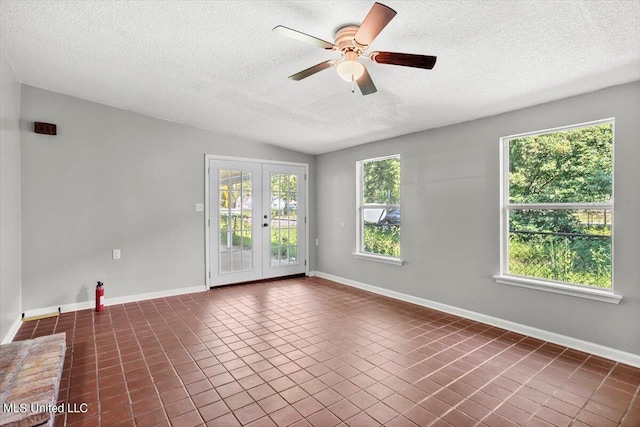 spare room with french doors, lofted ceiling, a healthy amount of sunlight, and ceiling fan