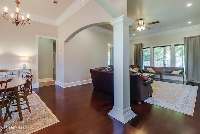 dining room with ornamental molding, dark wood-type flooring, and ceiling fan with notable chandelier