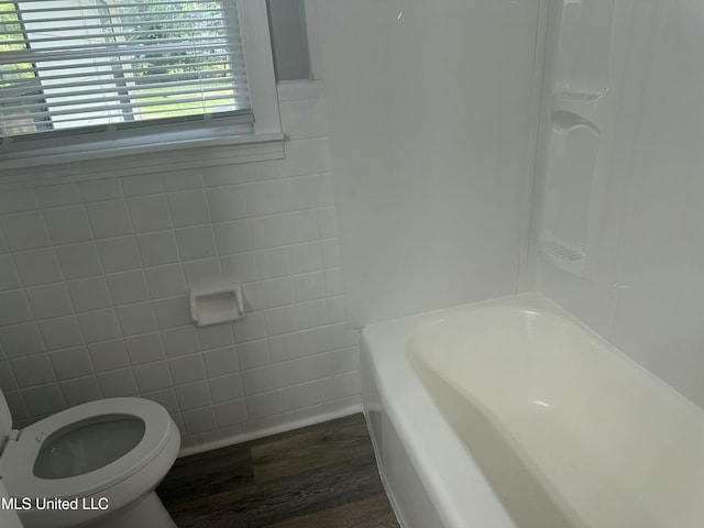 558 Daniel Cir, Jackson, MS 39212 - bathroom with toilet, wood finished floors, and tile walls