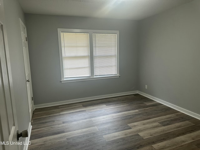 558 Daniel Cir, Jackson, MS 39212 - empty room with dark wood-style floors and baseboards