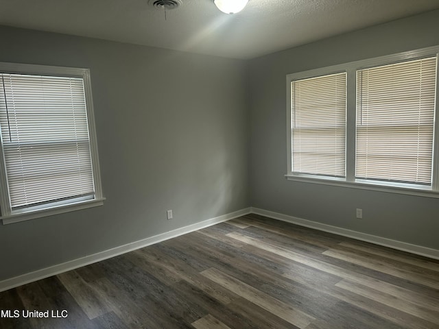 558 Daniel Cir, Jackson, MS 39212 - unfurnished room with dark wood-style flooring and baseboards