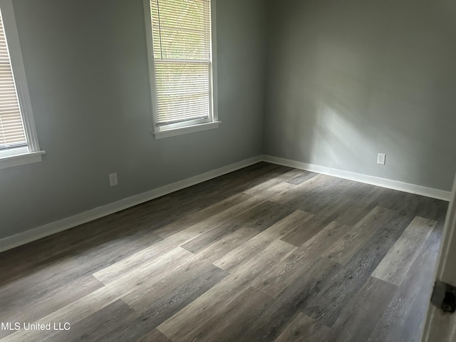 558 Daniel Cir, Jackson, MS 39212 - unfurnished room with dark wood finished floors, healthy amount of natural light, and baseboards