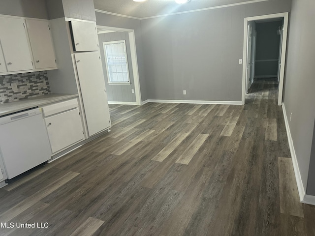558 Daniel Cir, Jackson, MS 39212 - unfurnished dining area featuring crown molding, baseboards, and dark wood-type flooring
