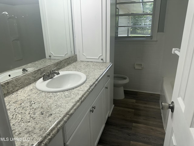 558 Daniel Cir, Jackson, MS 39212 - full bath featuring tile walls, vanity, wood finished floors, and toilet