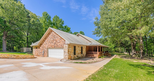4005 Warriors Trl, Vicksburg, MS 39180 - view of front of house featuring a porch, a garage, driveway, a front yard, and brick siding