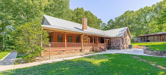4005 Warriors Trl, Vicksburg, MS 39180 - view of front of house featuring covered porch, a front yard, a chimney, and metal roof