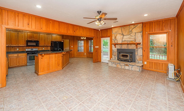4005 Warriors Trl, Vicksburg, MS 39180 - kitchen featuring black appliances, wooden walls, ornamental molding, open floor plan, and ceiling fan