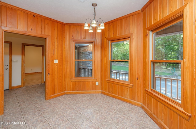 4005 Warriors Trl, Vicksburg, MS 39180 - unfurnished room featuring a chandelier, wooden walls, ornamental molding, and baseboards